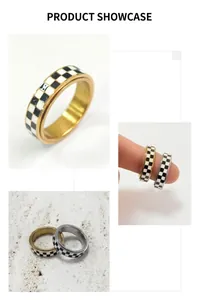 Close-up of gold and silver spinner rings with black and white checkered enamel inlay