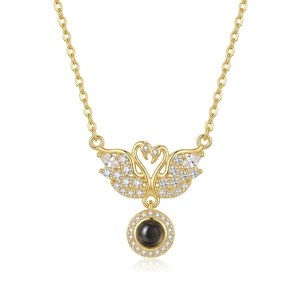 Elegant gold double swan necklace with pavé crystal accents and a round projection stone