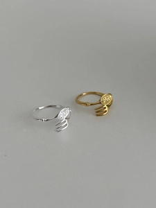 Detailed close-up of creative gold and silver fork and spoon rings with micro-inlaid stones