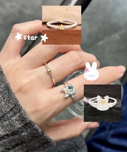 Detail of S925 sterling silver adjustable rings with gold star and rabbit design