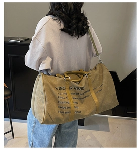 Detail of the large canvas travel tote showing side view and size on a person