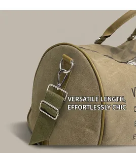 Detail of adjustable canvas shoulder strap with silver metal hooks on the travel tote bag
