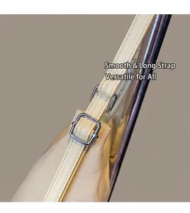 Detail of adjustable cream faux leather straps with silver square buckles on tote bag