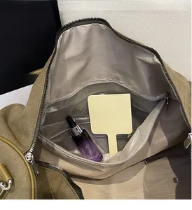 Detail view of khaki travel bag showing internal waterproof wet-dry separation pocket