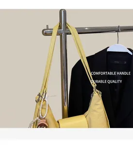 Detail of light yellow nylon tote bag with pearl pendant and cute cartoon charm