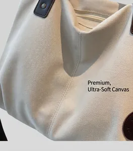 Detailed macro view of high-quality canvas texture with brown leather logo patch and strap
