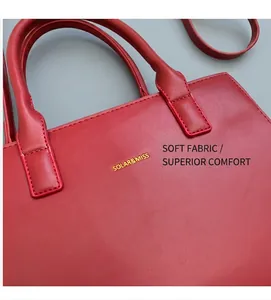 Close-up of deep red leather handbag texture and gold SOLAR&MISS brand logo