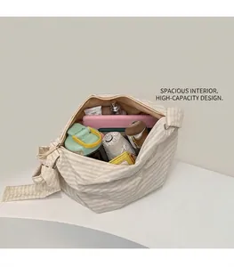 Spacious interior of striped fabric tote bag holding water bottle, tablet and cosmetics