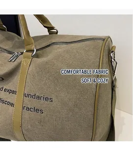 Detail of durable canvas travel bag with side slogan print and faux leather handle