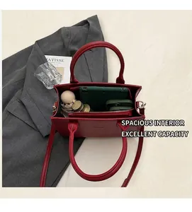 Top view of red leather tote bag showing large capacity for tablet and daily essentials