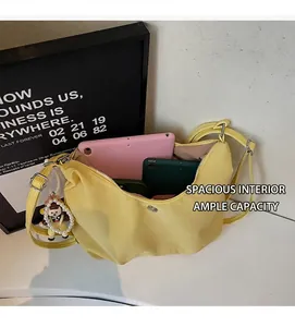 Interior view of yellow crescent nylon bag showing large capacity for tablets and phones