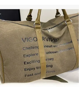 Detail of army green travel tote with reinforced leather straps and printed typography