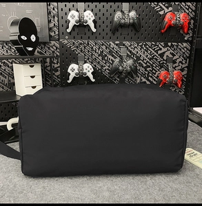 Detail of black nylon tote bag showing durable fabric texture and reinforced side structure