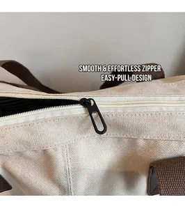 Detailed macro shot of a smooth black metal zipper head on a beige canvas tote bag
