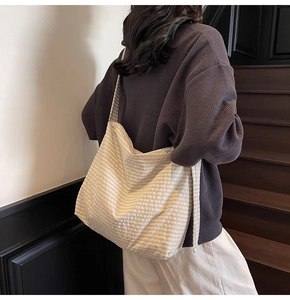 Detail of checkered canvas tote bag texture with minimalist beige and white pattern