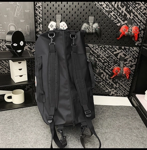 Detail of versatile black nylon tote bag with adjustable straps in a gaming room setting
