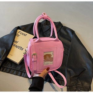 Pink glossy faux leather square handbag featuring a transparent ID card slot detail