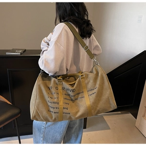 Detailed view of the large capacity canvas travel tote bag with adjustable shoulder strap