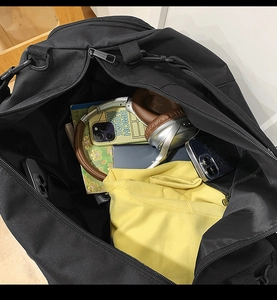 Top view of large black nylon tote bag interior showing ample storage and compartments