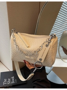 Chic cream crocodile pattern barrel bag with floral chain and adjustable strap