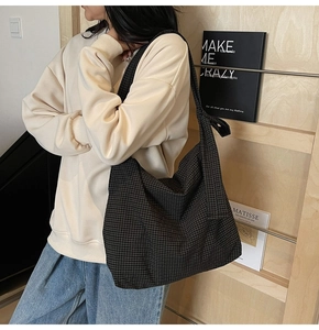 Close-up of a large capacity checkered tote bag styled for casual daily commuting