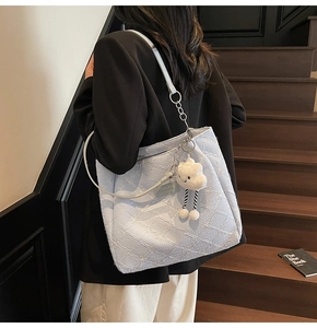 Detail of light blue floral jacquard tote bag with white embroidery and cloud charm
