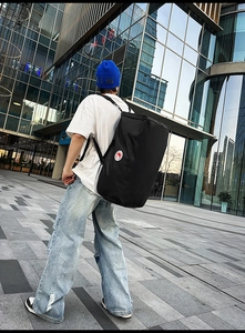 Macro shot of durable black nylon cylindrical backpack with a logo during urban commute
