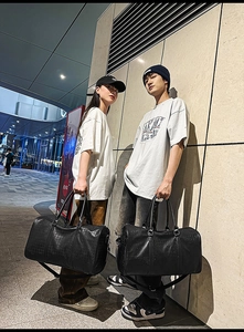 Close-up of black crocodile pattern faux leather travel tote bags for men and women