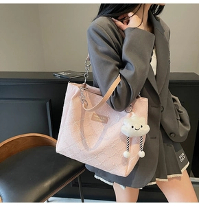 Pink jacquard tote bag with chain strap and cloud charm detail shown on model