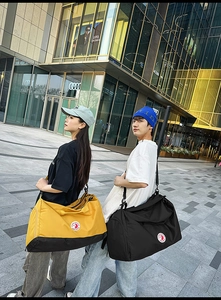 Detail of multi-functional nylon tote bag showing separate shoe compartment and carry straps