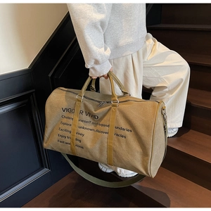 Olive green canvas travel bag detail featuring VIGOR VIVID branding and sturdy handles