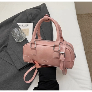 Detailed view of pink bowling bag with silver zipper and adjustable shoulder strap