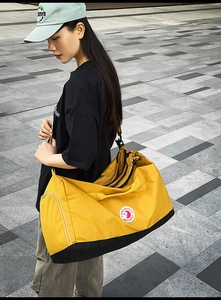 Detailed side view of the yellow large-capacity nylon tote bag with adjustable strap