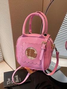 Pink patent leather square handbag with dog pattern window and adjustable shoulder strap
