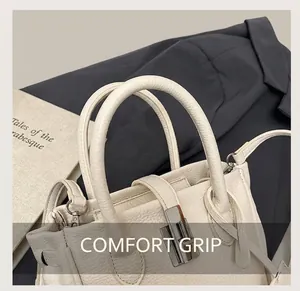 Close-up of white lychee pattern leather handbag with silver metallic twist lock details