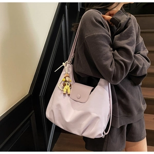 Lavender purple canvas shoulder bag with a cute monkey charm and stylish pearl chain detail