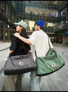 Detail of multi-functional nylon tote bag with round logo and adjustable shoulder strap