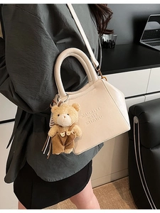 Chic beige leather shoulder bag with plush bear charm and adjustable strap for women