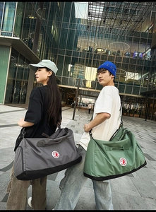Detailed view of gray and green nylon tote bags featuring reinforced base and crossbody straps