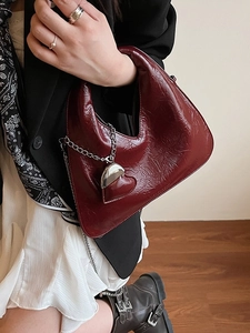 Burgundy pleated leather crescent handbag with silver chain and heart charm detail