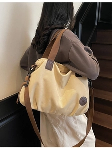 Waterproof large capacity travel tote bag with brown straps in a beige canvas finish