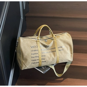 Macro detail of khaki canvas travel tote with faux leather handles on wooden stairs