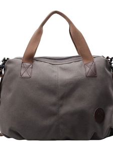 Waterproof large capacity canvas travel duffel bag with brown handles and reinforced stitching