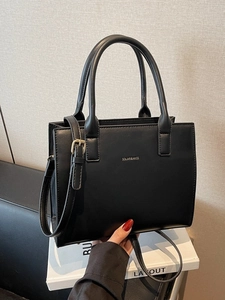 Elegant black leather tote bag with handles and adjustable shoulder strap for women
