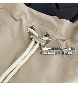 Detail of the adjustable drawstring closure with metal stopper and silver eyelets on nylon bag