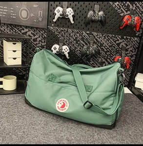 Macro detail of dark green nylon tote bag with circular logo and reinforced black base