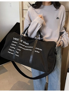 Black canvas travel tote bag with Vigor Vivid slogan and adjustable crossbody strap