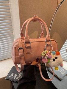 Pink retro bowling bag with fluffy monster charm and adjustable shoulder strap