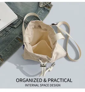 Detailed interior view of ivory nylon bucket bag showing storage compartments and drawstring