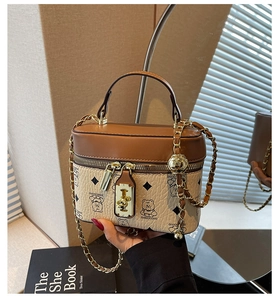 Detail view of the mini bucket bag showing two-tone leather and bear printed patterns